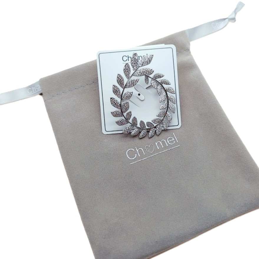 Cubic Zirconia Brooch in a silver-tone finish, shaped as an oval wreath of sparkling leaf details.