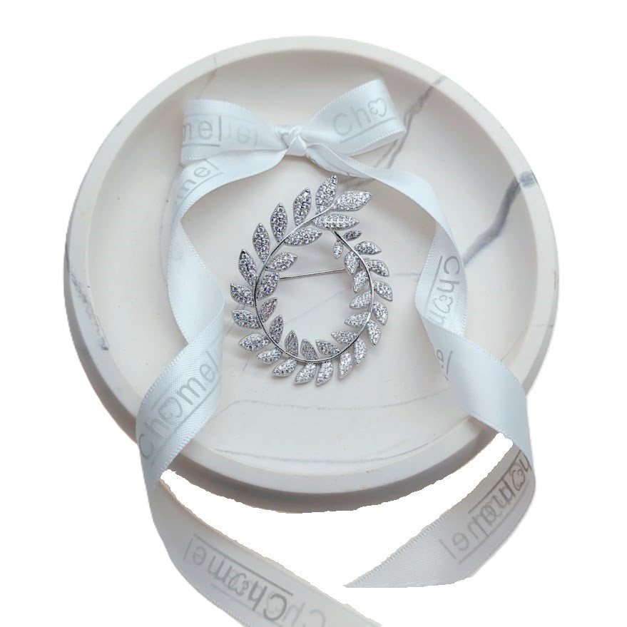 Cubic Zirconia Brooch in a silver-tone leafy wreath design, with clear stones and a delicate pin fastening.