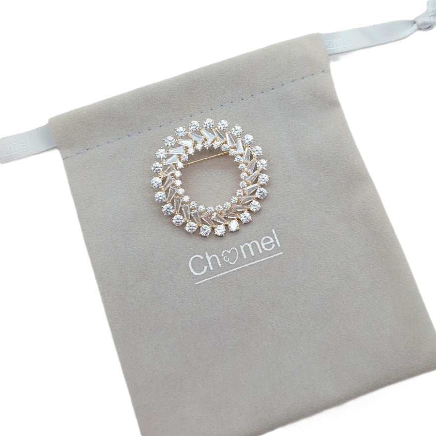 Gold plated round cubic zirconia brooch with round and baguette cut stones, 4.5cm diameter