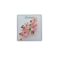 Cubic Zirconia Brooch with gold-tone floral branches, pink crystal blossoms, red flower accents, and green leaf details.