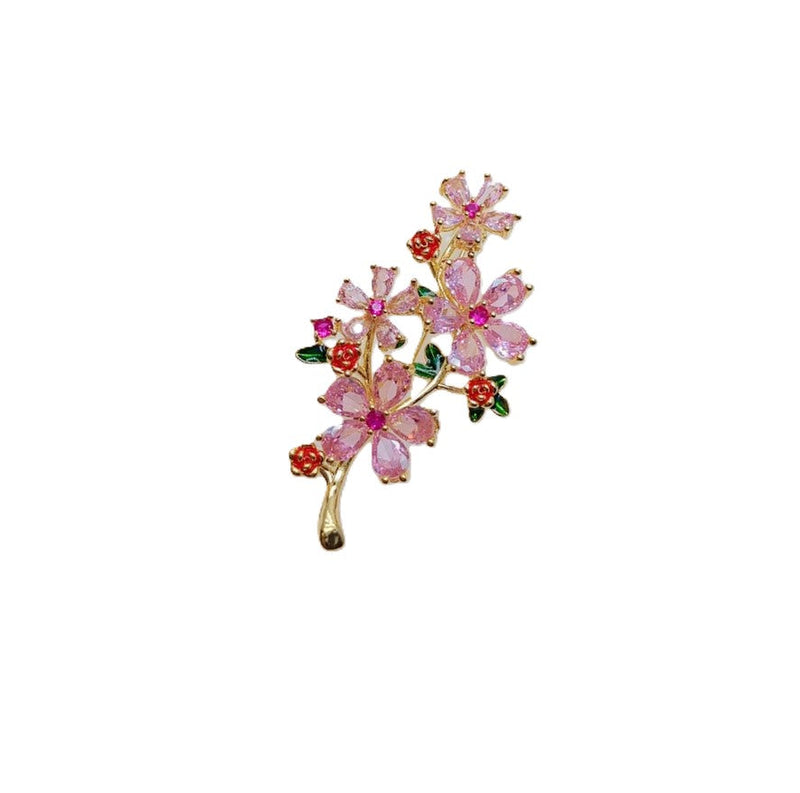 Cubic Zirconia Brooch with gold-tone branch, pink flowers, red rose accents and dark green leaves set with sparkling stones.