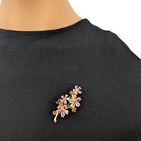 Cubic Zirconia Brooch with gold-tone floral clusters, sparkling pink and clear stones, and small green leaf accents