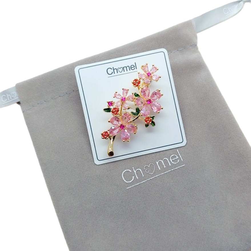 Cubic Zirconia Brooch in gold-tone metal, with pink floral clusters, small red accents and green leaf details.