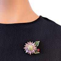 Pink cubic zirconia flower cubic zirconia brooch with green enamel leaves and red beetle detail, gold plated, 4.1cm x 3.6cm.