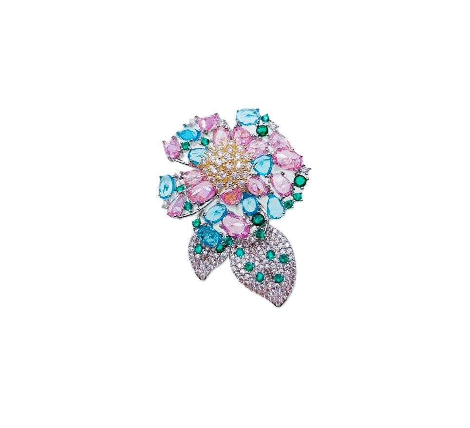 Flower cubic zirconia brooch with pastel pink and blue stones, green leaf accents, rhodium plated, 3.6x5cm size