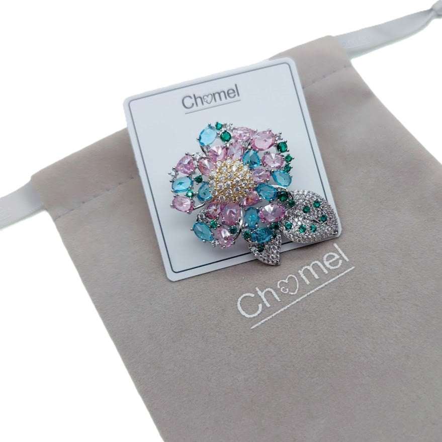 Flower cubic zirconia brooch with pastel pink and blue stones, green leaf accents, rhodium plated, 3.6cm by 5cm