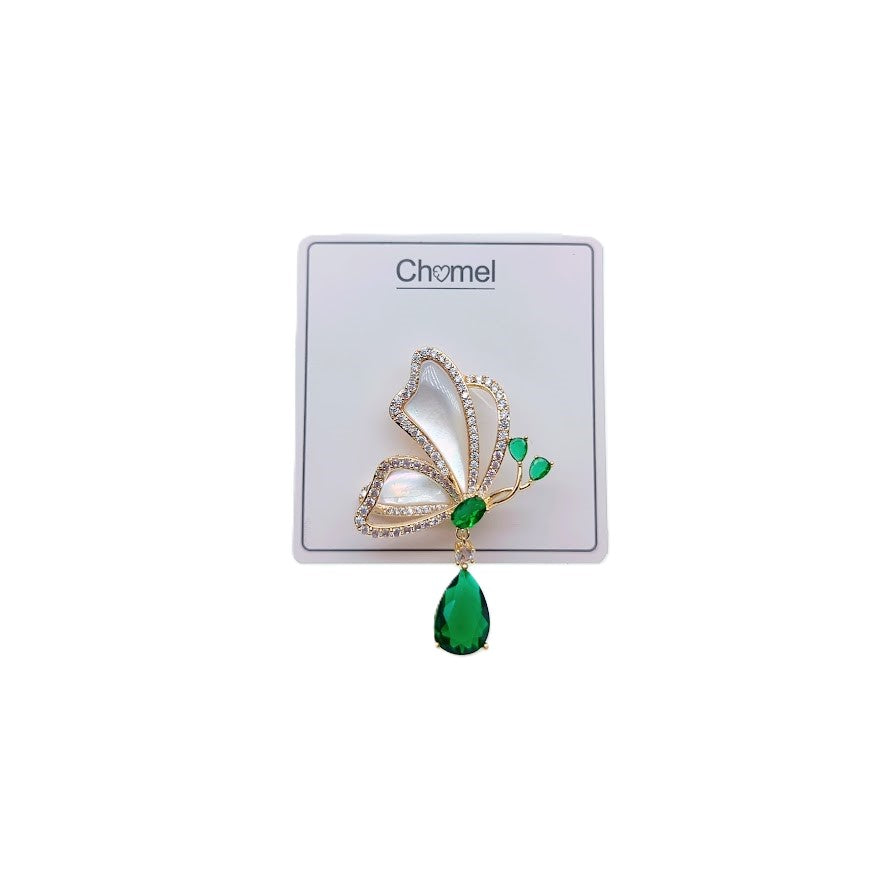 Gold plated butterfly brooch with cubic zirconia, mother of pearl, and dangling green teardrop stone