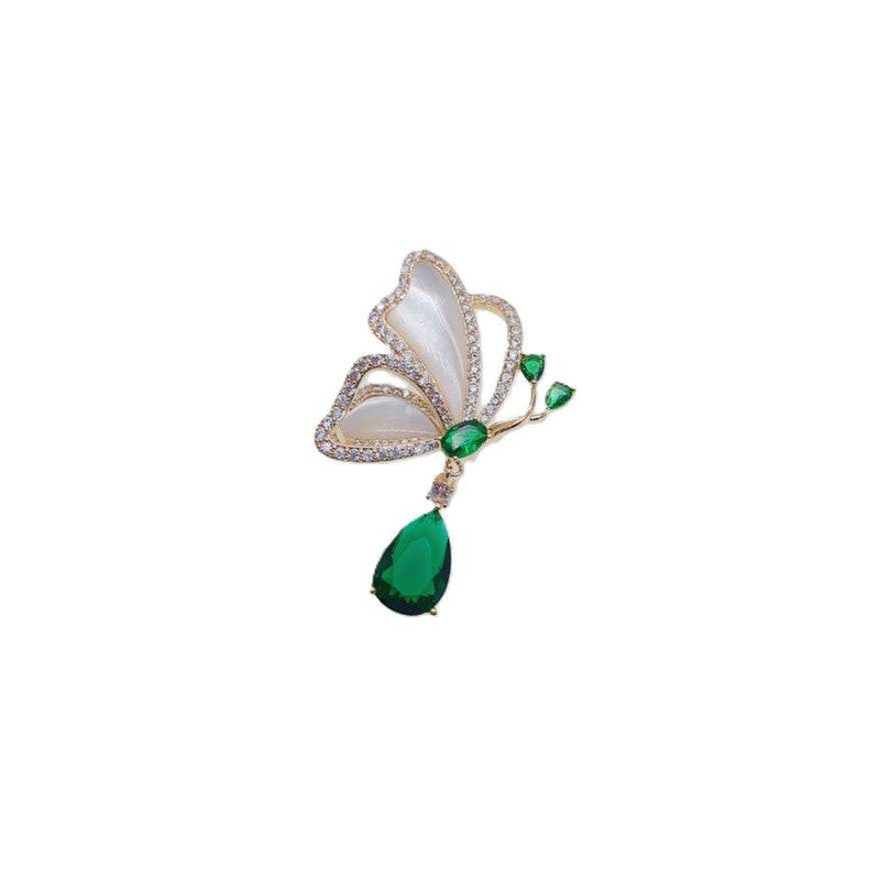 Gold plated butterfly cubic zirconia brooch with mother of pearl and dangling green teardrop stone