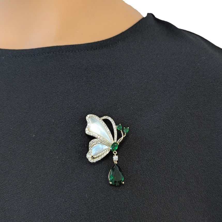 Butterfly cubic zirconia brooch with mother of pearl and dangling green teardrop stone, gold plated finish