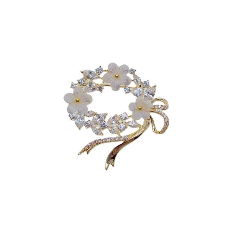 Gold plated oval flower cubic zirconia brooch with moonstone flowers and ribbon detail