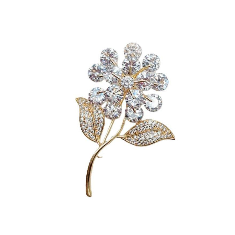 Gold-plated flower and leaf cubic zirconia brooch with C clasp closure