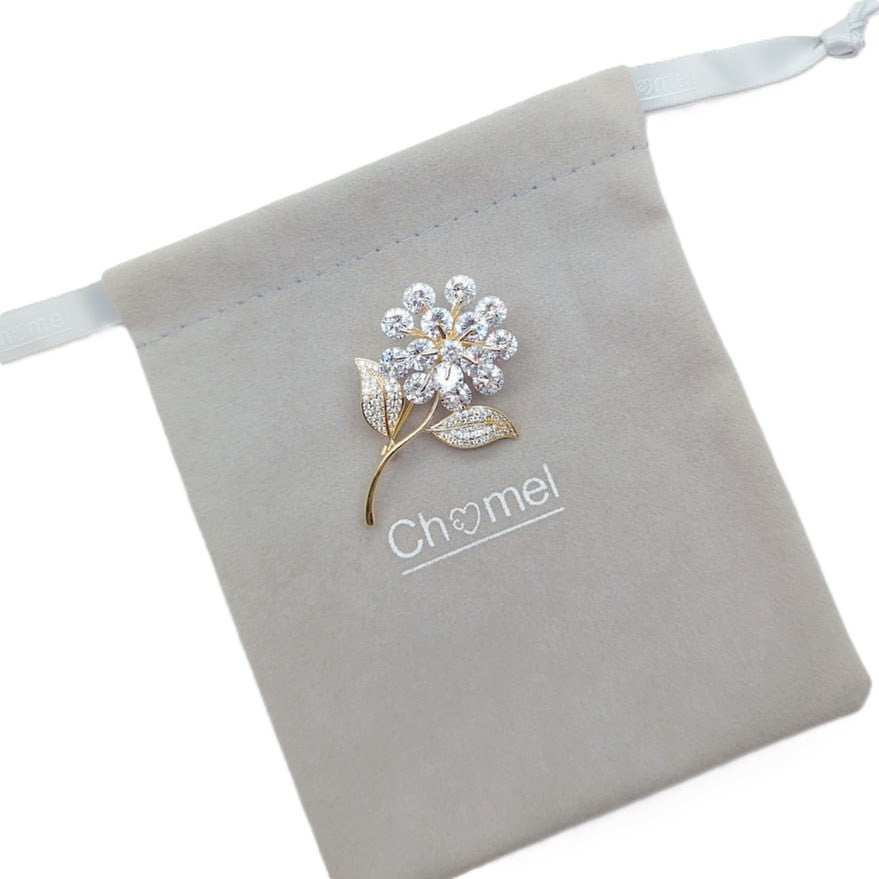 Gold plated leaf cubic zirconia brooch with flower stalk and sparkling stones