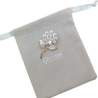 Gold plated leaf cubic zirconia brooch with flower stalk and sparkling stones