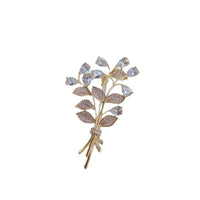 Gold-plated leaf cubic zirconia brooch with bouquet design and C clasp closure, 3.9cm by 6cm