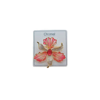 Cubic Zirconia Brooch featuring a coral pink and gold orchid flower with sparkling clear stones and a red center gem.