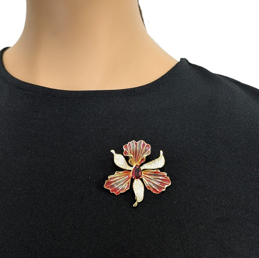 Cubic Zirconia Brooch shaped like a red and gold orchid, with textured petals and sparkling central accents.