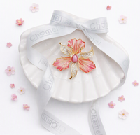 Pink orchid Cubic Zirconia Brooch with gold-tone outlines, sparkling clear stones and a pink centre.