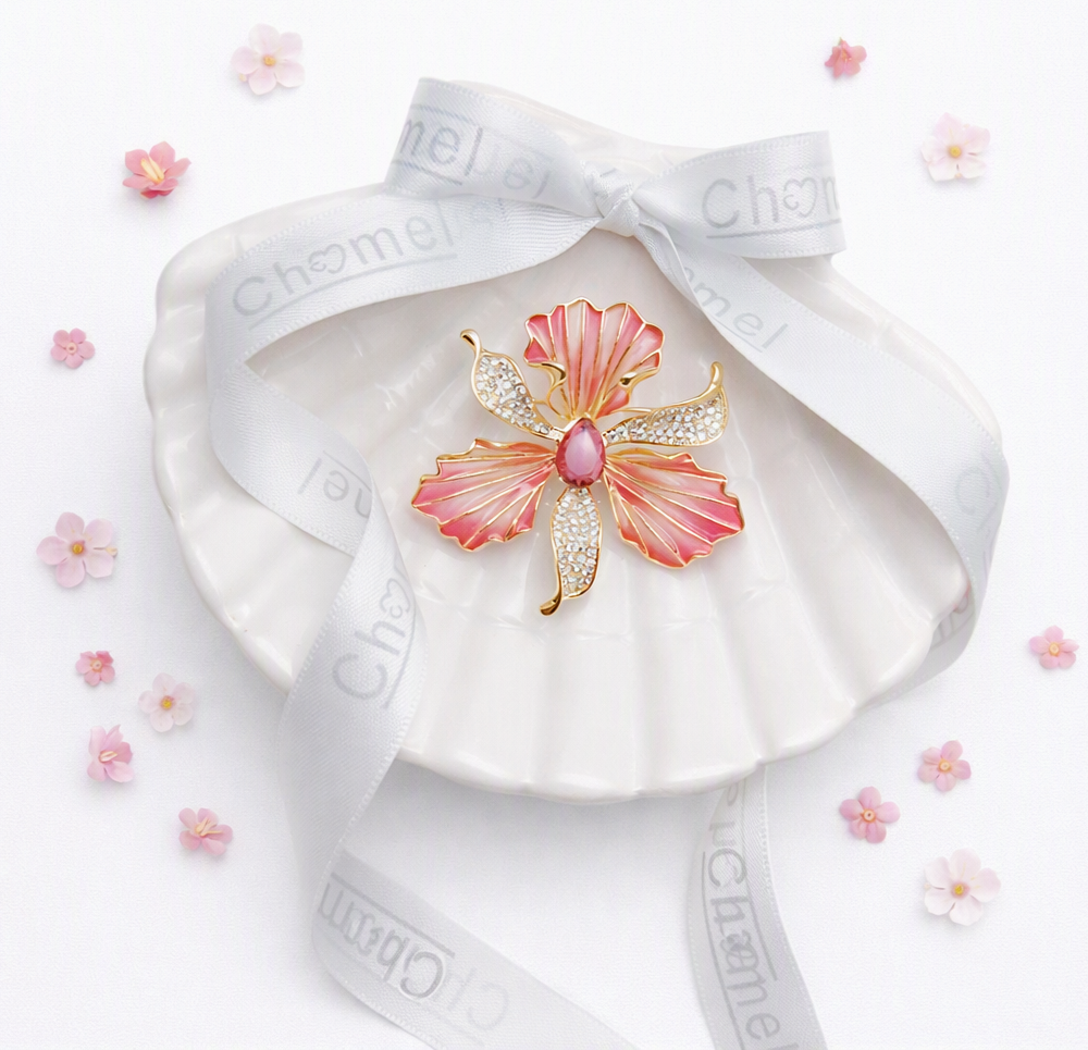 Pink orchid Cubic Zirconia Brooch with gold-tone outlines, sparkling clear stones and a pink centre.