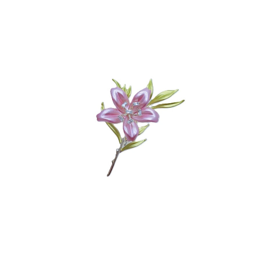 Cubic Zirconia Brooch with a lavender-pink enamel flower, clear sparkling accents, green enamel leaves and a slim stem.