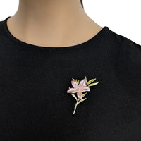 Cubic Zirconia Brooch with a delicate pink enamel flower, sparkling accents, green leaves and a gold-tone stem.
