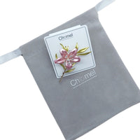 Cubic Zirconia Brooch featuring a pink enamel flower with gold-toned leaves and a slender pin stem.