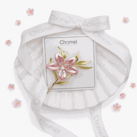 Cubic Zirconia Brooch featuring a pink flower with sparkling clear accents and gold-tone leaves, on a card.