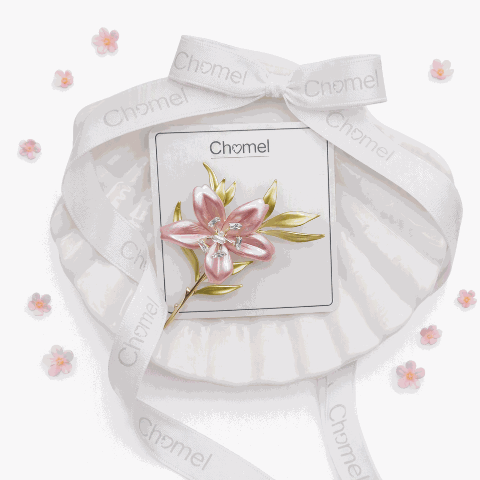 Cubic Zirconia Brooch featuring a pink flower with sparkling clear accents and gold-tone leaves, on a card.