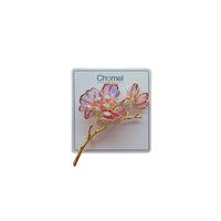 Cubic Zirconia Brooch featuring two pink and purple enamel flowers, sparkling crystal accents, and a gold-tone twig stem.