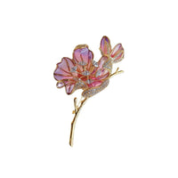 Cubic Zirconia Brooch featuring a pink enamel flower with sparkling crystal accents, purple petals and a gold-tone stem.