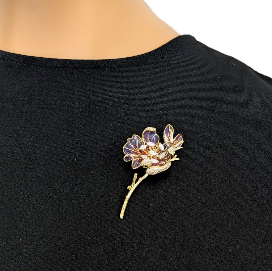 Cubic Zirconia Brooch with a gold-tone twig, purple enamel flower petals and sparkling clear accents.