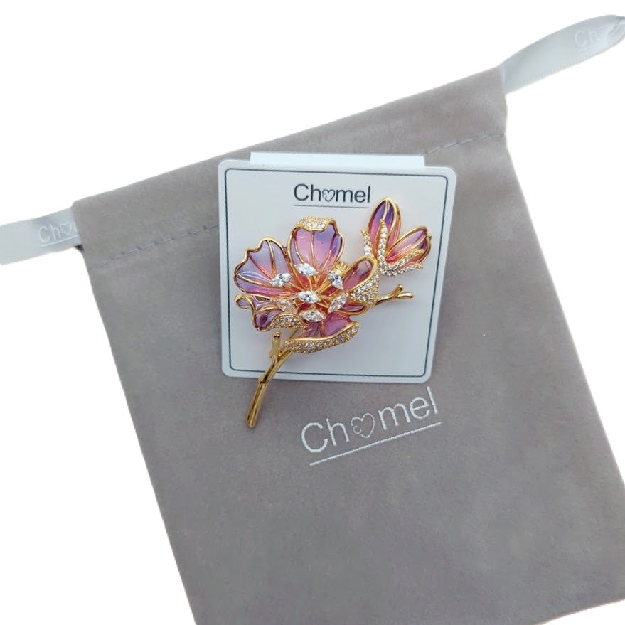 Cubic Zirconia Brooch with a pink and lavender enamel flower, gold-tone trim, sparkling clear stones and a slender stem.