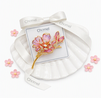 Flower Cubic Zirconia Brooch with pink enamel petals, gold-tone twig and sparkling crystal accents.