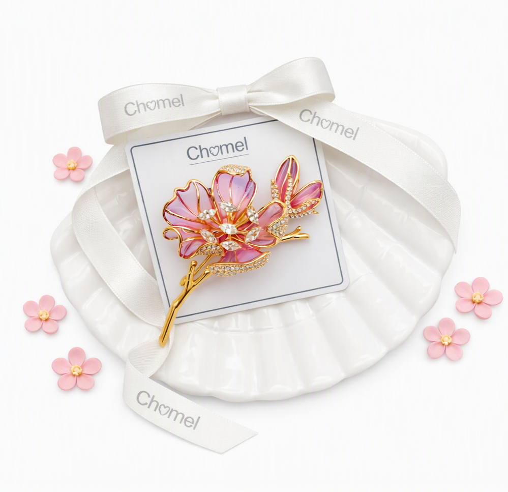 Flower Cubic Zirconia Brooch with pink enamel petals, gold-tone twig and sparkling crystal accents.