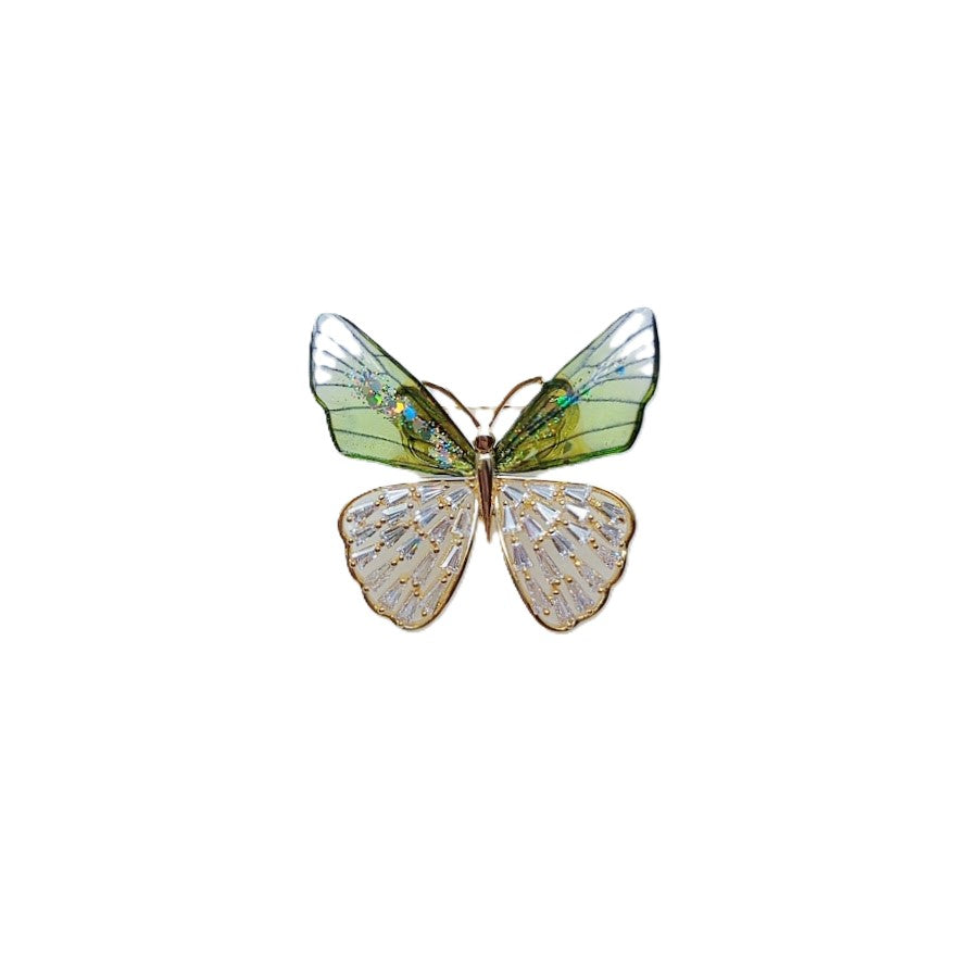 Butterfly cubic zirconia brooch with translucent green enamel upper wings, sparkling clear lower wings and gold-tone edging.