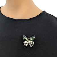 Butterfly cubic zirconia brooch in gold-tone metal, with pale green enamel wings and sparkling clear stones.