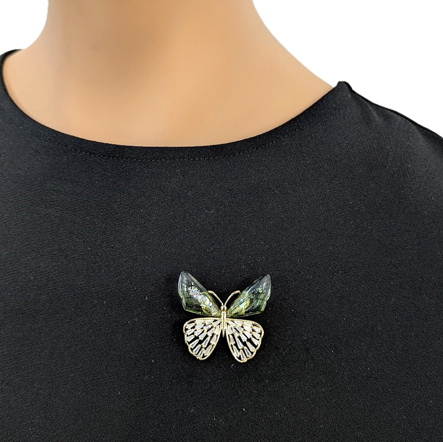 Butterfly cubic zirconia brooch in gold-tone metal, with pale green enamel wings and sparkling clear stones.