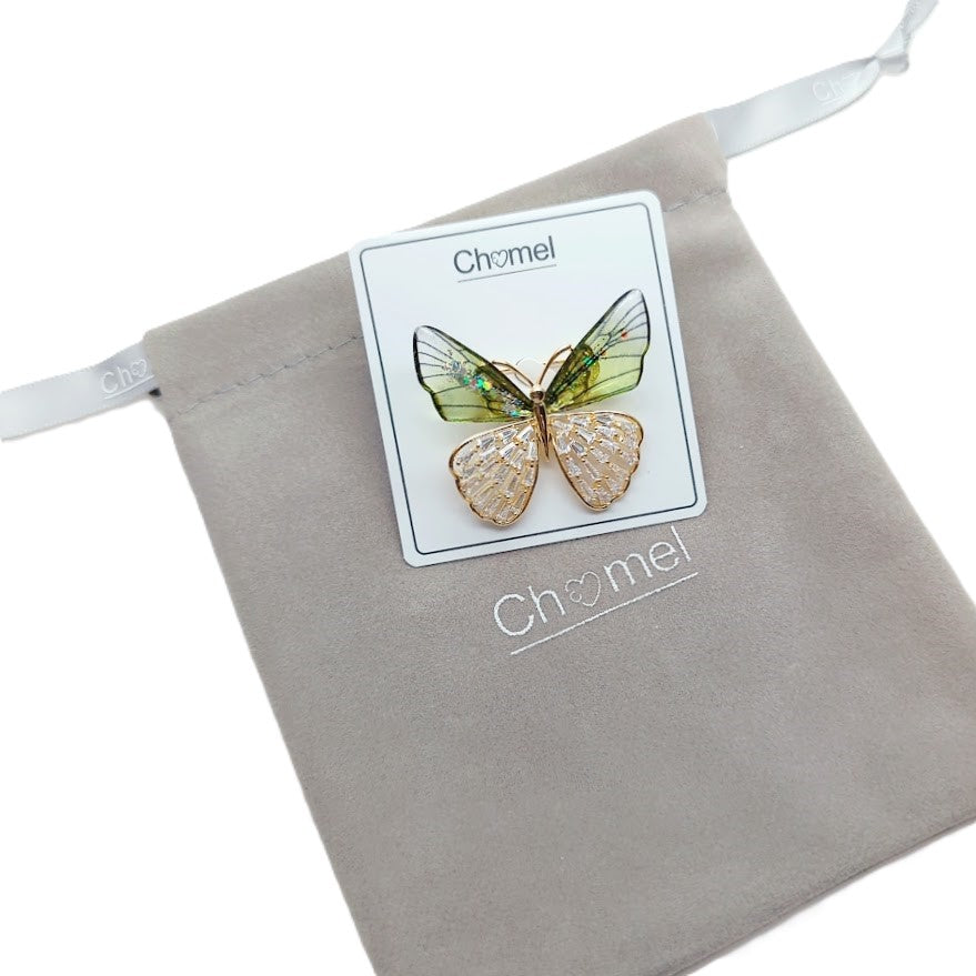 Butterfly cubic zirconia brooch with gold-tone metal, pale green and champagne wings, and sparkling stone details.