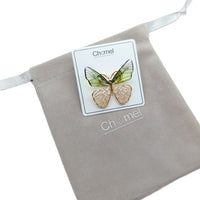 Butterfly cubic zirconia brooch with gold-tone metal, pale green and champagne wings, and sparkling stone details.