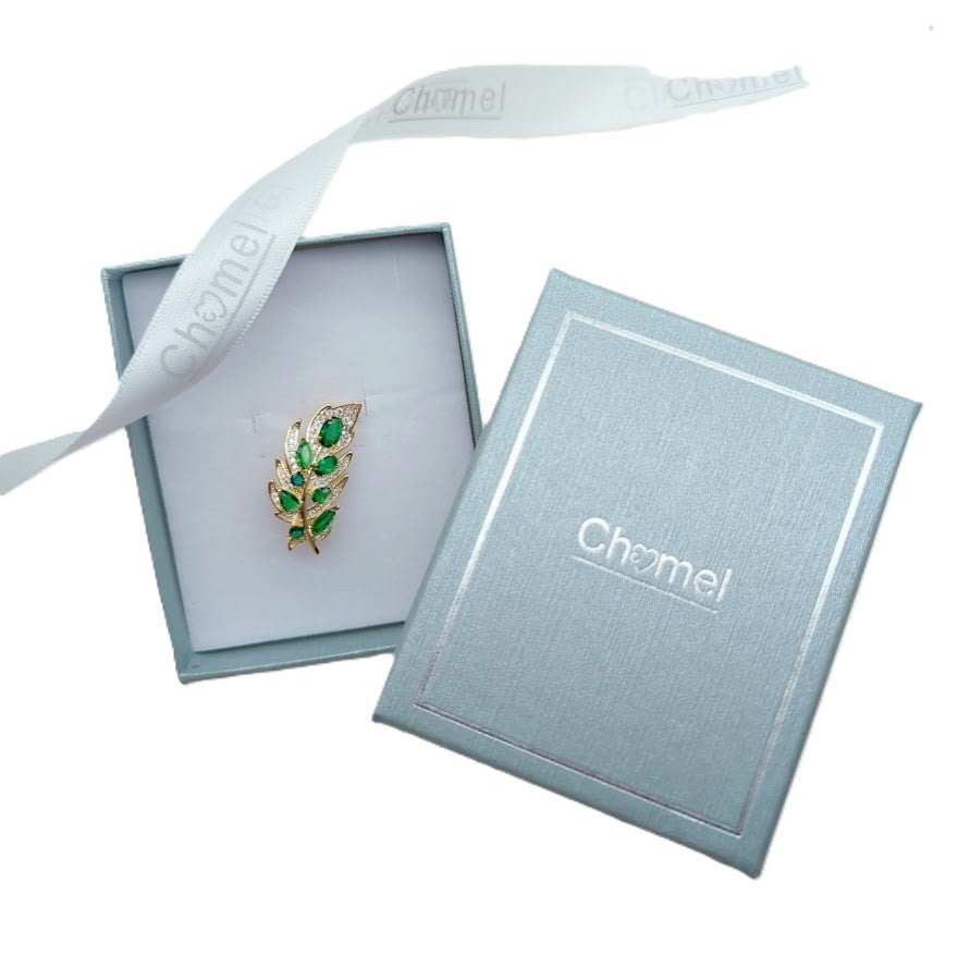 Gold plated maple leaf cubic zirconia brooch with green stones and C clasp closure