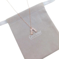 Rose gold peanut cubic zirconia necklace with three simulated pearls pendant on adjustable chain
