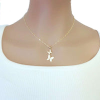 Butterfly Cubic Zirconia Necklace in gold-tone metal, with two small white butterfly charms featuring sparkling accents and a twisted chain.