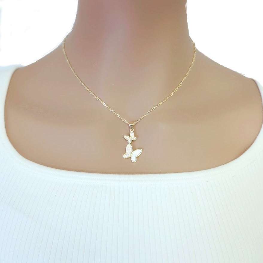 Butterfly Cubic Zirconia Necklace in gold-tone metal, with two small white butterfly charms featuring sparkling accents and a twisted chain.
