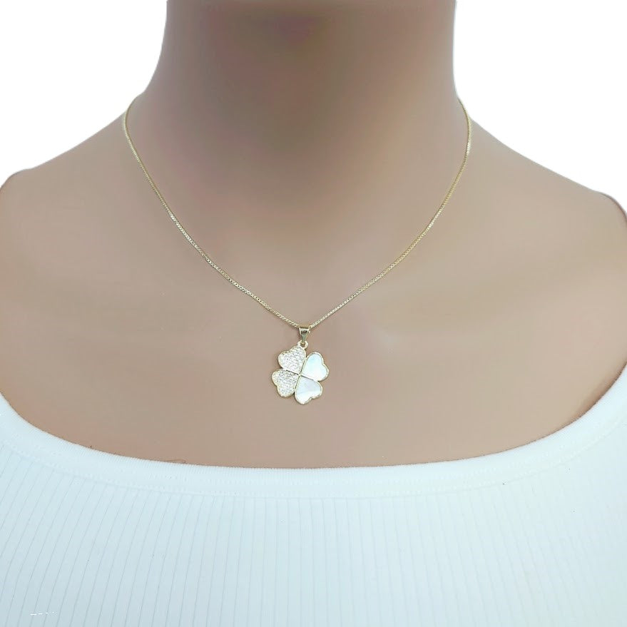 Gold-tone necklace with a four-leaf clover pendant featuring pearly white insets and sparkling stones; Butterfly Cubic Zirconia detail.