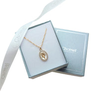 Gold-plated necklace with an oval mother-of-pearl pendant, flower motif and sparkling border; Butterfly Cubic Zirconia detail.