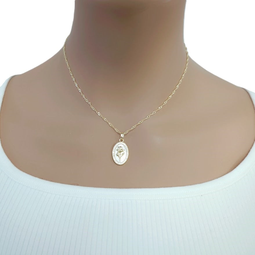 Gold-tone necklace with a fine twisted chain and oval mother-of-pearl pendant, accented by a floral motif and sparkling border; Butterfly Cubic Zirconia detail.