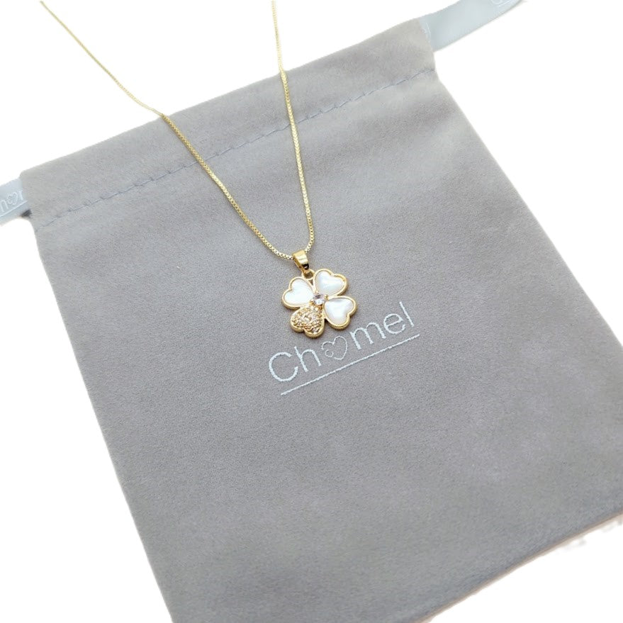 Clover pendant necklace in gold-tone metal with white mother-of-pearl petals and a sparkling accent; Butterfly Cubic Zirconia detail.