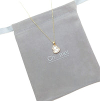 Gold-tone chain necklace with a small mother-of-pearl pendant edged in sparkling cubic zirconia; Dream Catcher Cubic Zirconia Necklace.