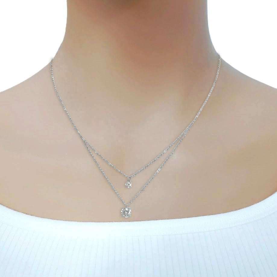 Cubic zirconia layered necklace with 4mm and 7mm solitaires in rhodium plated finish