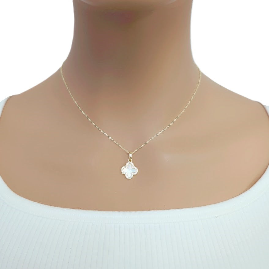 Gold-tone necklace with a delicate chain and white clover-shaped pendant edged in sparkling stones, Butterfly Cubic Zirconia style.