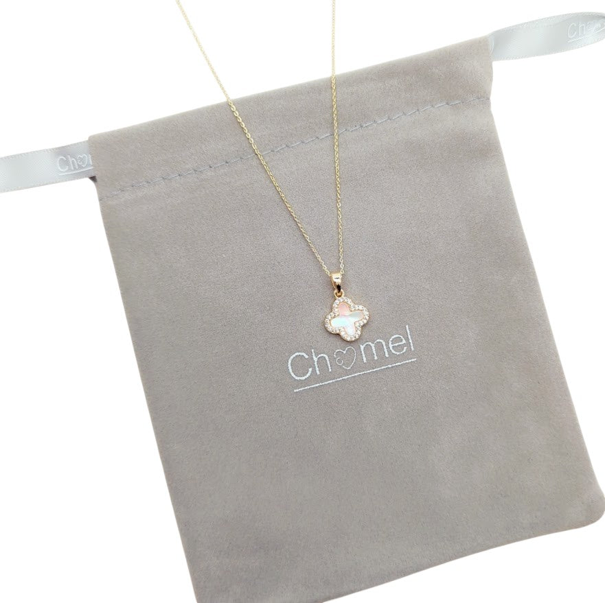 Gold-tone necklace with a mother-of-pearl clover pendant edged in sparkling stones; Butterfly Cubic Zirconia detail.